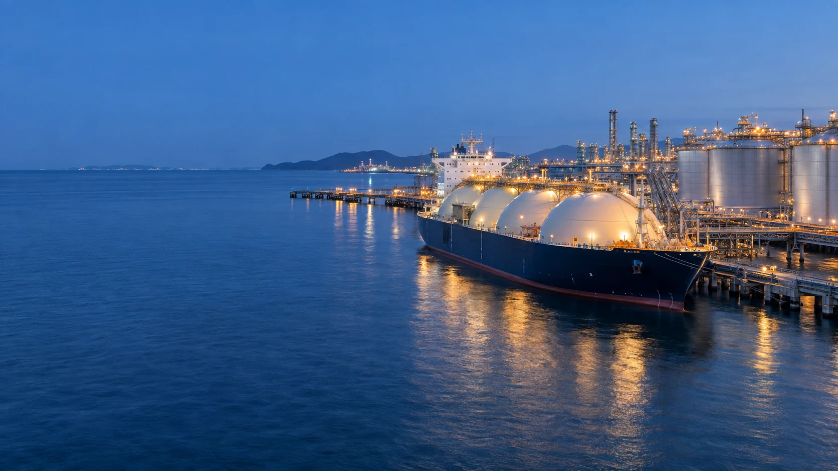 Illustrative energy port with an LNG tanker and oil storage tanks